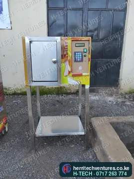 A compact stainless oil ATM with keypad controller on a stainless stand, December 2022