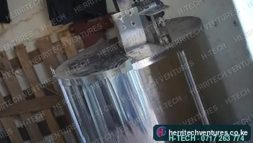 A stainless steel tank with a motor-driven stirrer, January 2019