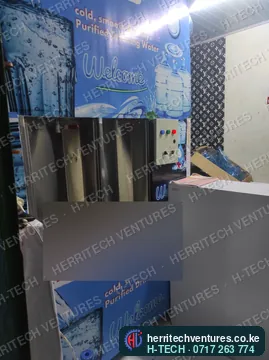 A branded refilling station front with refill bays and control buttons, installed in a customer's shop, December 2021