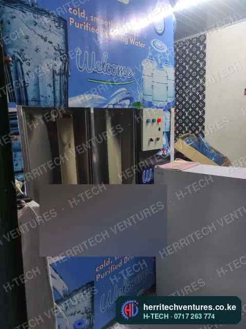 A branded refilling station front with refill bays and control buttons, installed in a customer's shop, December 2021